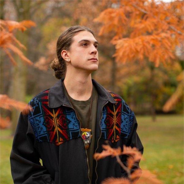 GVSU senior Simon Baker poses for a portrait outdoors.